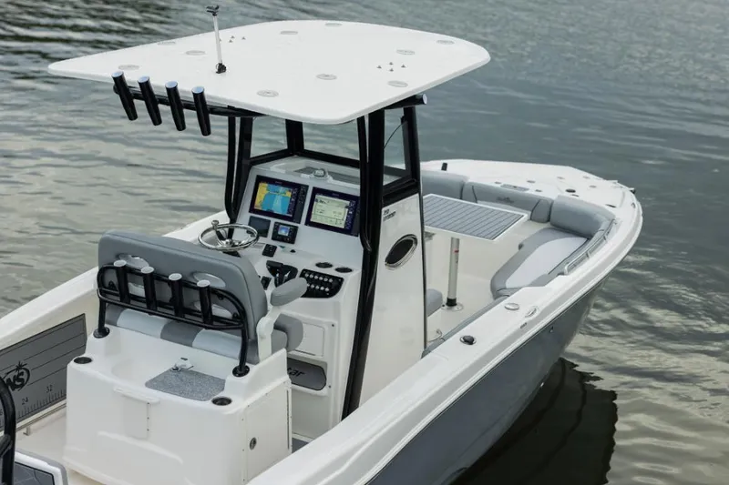 Slide: The Image of 2023 NauticStar 251 Hybrid boat on trailer, parked outdoors, autumn setting. - 2