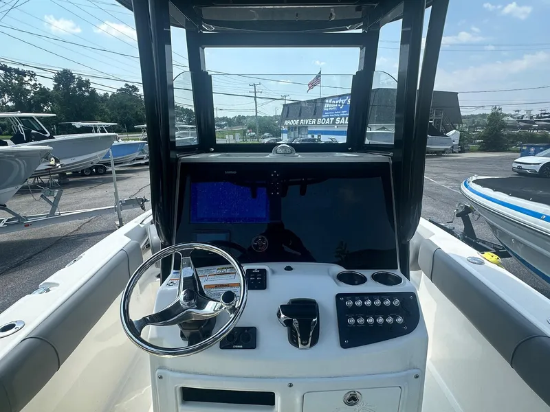 Slide: The Image of 2023 NauticStar 251 Hybrid boat storage compartment with open hatch, showcasing interior space. - 22