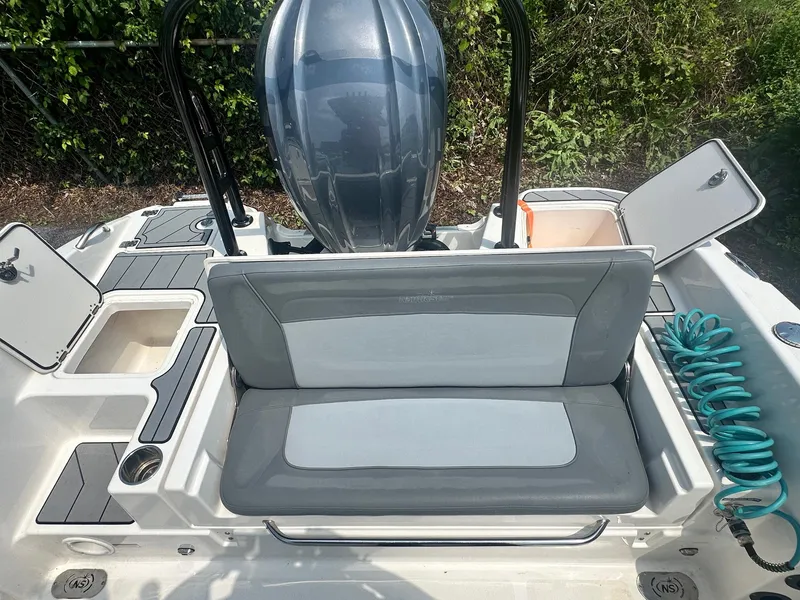 Slide: The Image of 2023 NauticStar 251 Hybrid boat interior with seating and storage in a parking lot. - 24