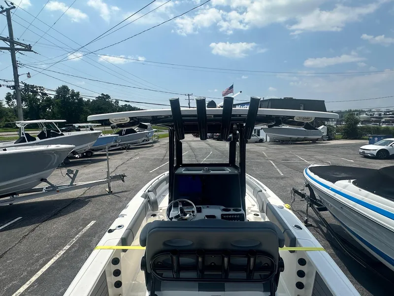 Slide: The Image of 2023 NauticStar 251 Hybrid boat dashboard with steering wheel and control panel. - 27
