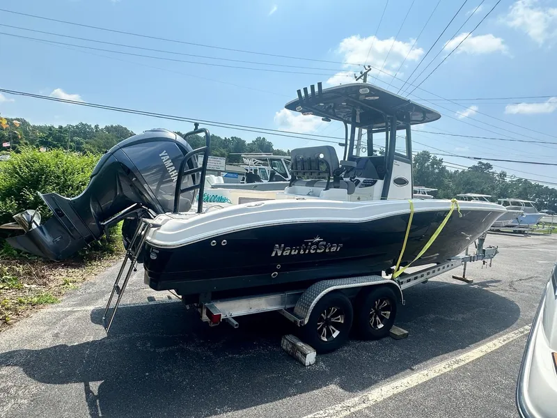 Slide: The Image of 2023 NauticStar 251 Hybrid boat interior with seating and storage compartments. - 29
