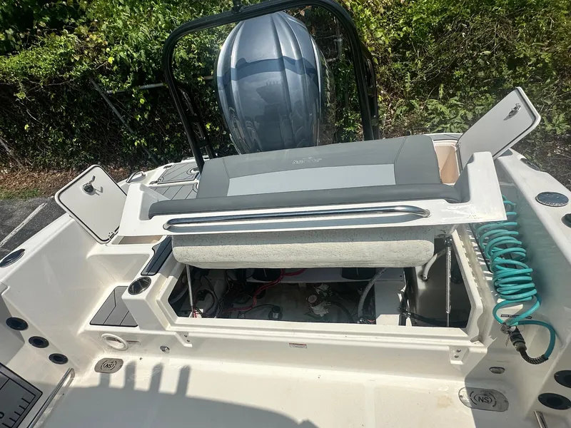 Slide: The Image of 2023 NauticStar 251 Hybrid boat on trailer, parked outdoors at sunset. - 5