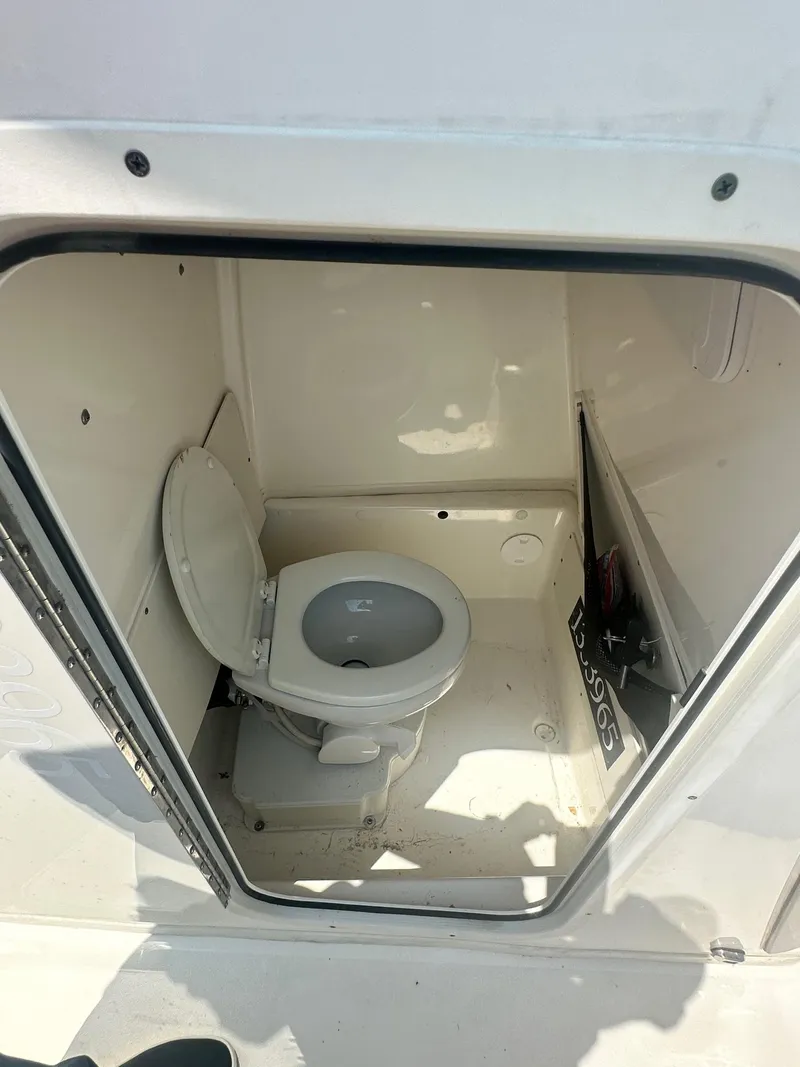 Slide: The Image of 2023 NauticStar 251 Hybrid boat on trailer, parked on gravel lot. - 8