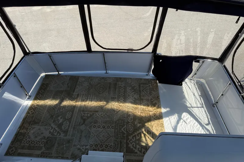 Slide: The Image of 1995 Carver 325 Aft Cabin interior with patterned carpet and enclosed seating area. - 27