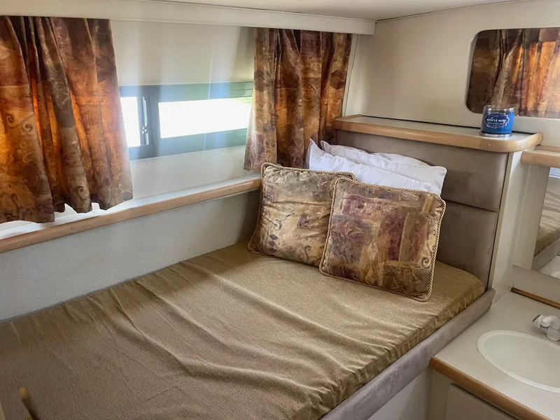 Slide: The Image of Cozy cabin interior of 1995 Carver 325 Aft Cabin with bed and decorative pillows. - 5