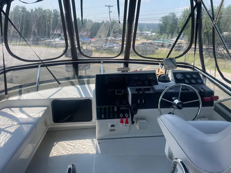 Slide: The Image of Interior view of 1995 Carver 325 Aft Cabin boat cockpit with steering wheel and controls. - 8