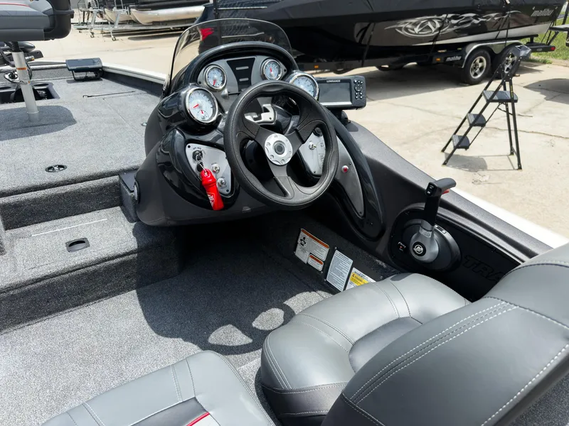 Slide: The Image of 2024 Tracker Pro Team 175 TXW boat interior with steering wheel and gauges. - 10