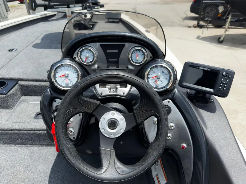 Slide: The Image of 2024 Tracker Pro Team 175 TXW boat dashboard with steering wheel and Lowrance fishfinder. - 11