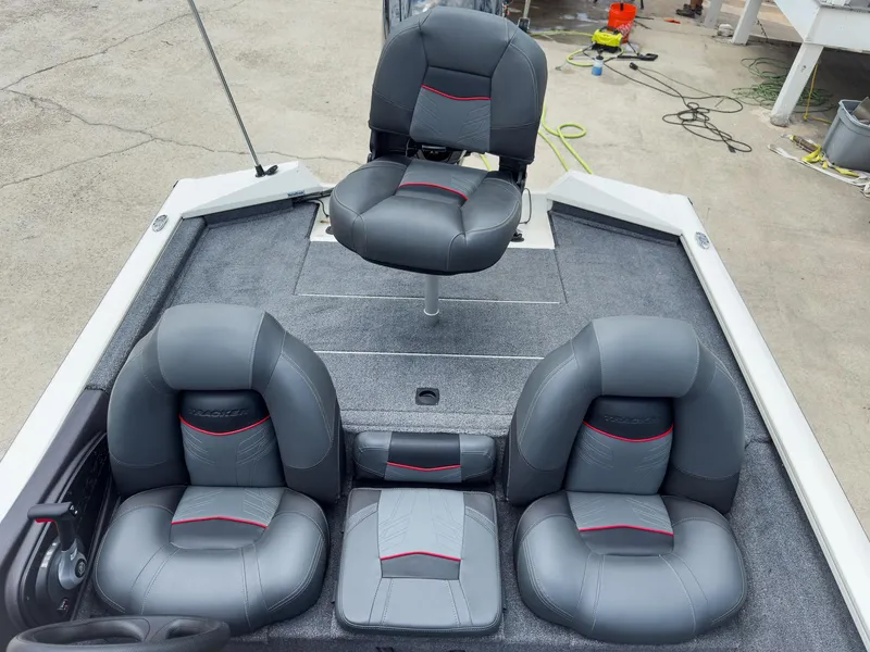 Slide: The Image of 2024 Tracker Pro Team 175 TXW boat interior with gray and red cushioned seats. - 15
