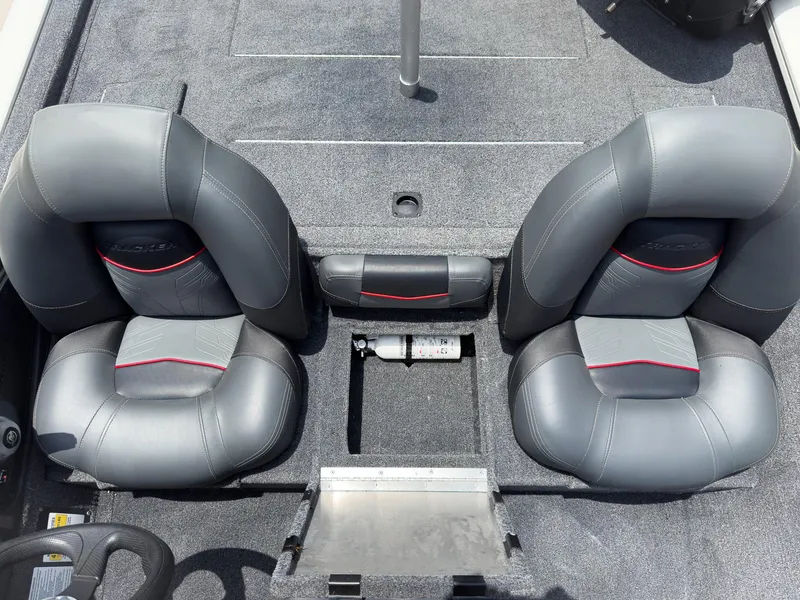 Slide: The Image of 2024 Tracker Pro Team 175 TXW boat interior with gray seats and storage compartments. - 16