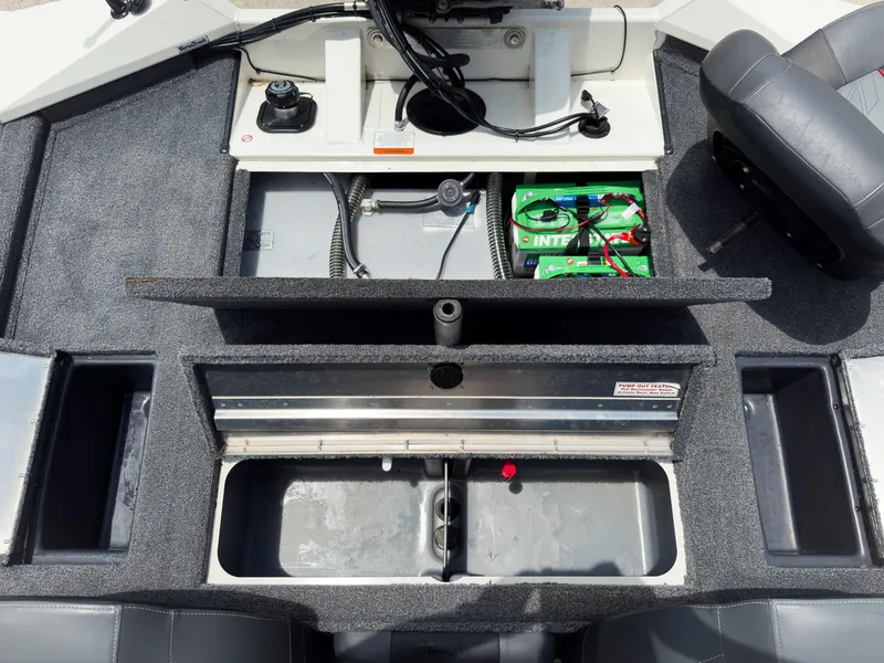 Slide: The Image of 2024 Tracker Pro Team 175 TXW boat interior with storage compartments and battery setup. - 18