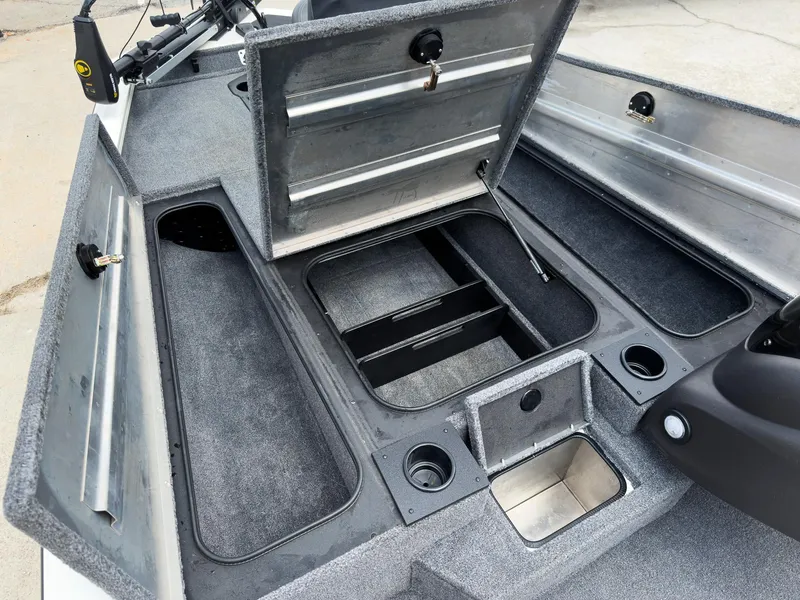Slide: The Image of 2024 Tracker Pro Team 175 TXW boat interior with open storage compartments. - 19