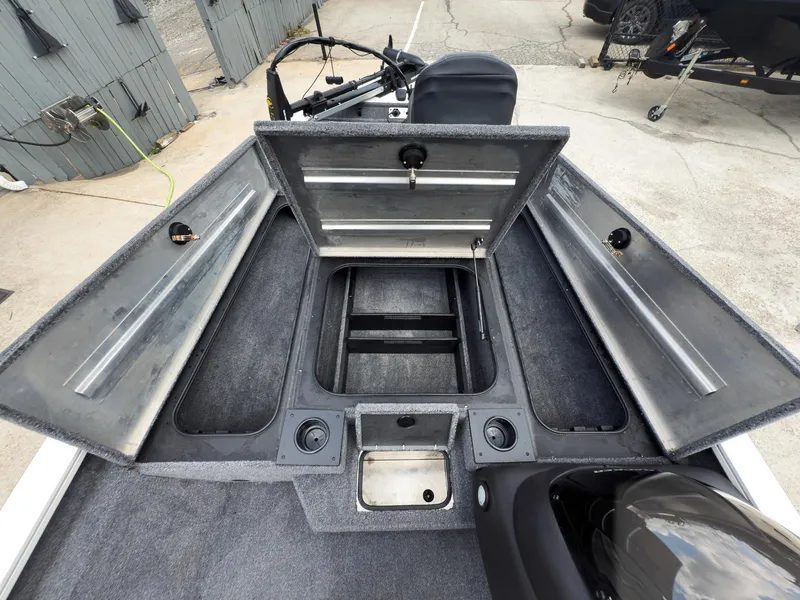 Slide: The Image of 2024 Tracker Pro Team 175 TXW boat interior with open storage compartments. - 20