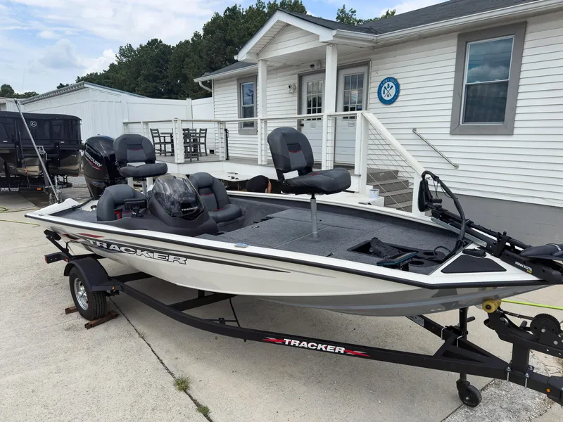 Slide: The Image of 2024 Tracker Pro Team 175 TXW boat on trailer, parked outside a building. - 3