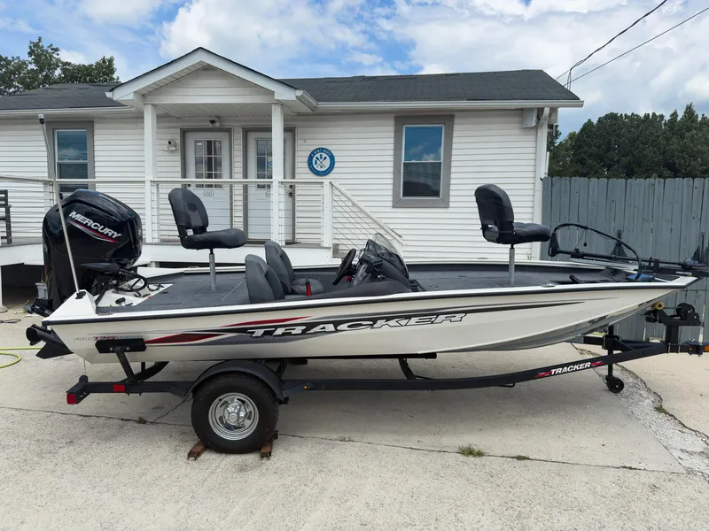 Slide: The Image of 2024 Tracker Pro Team 175 TXW boat parked outside a white building. - 4