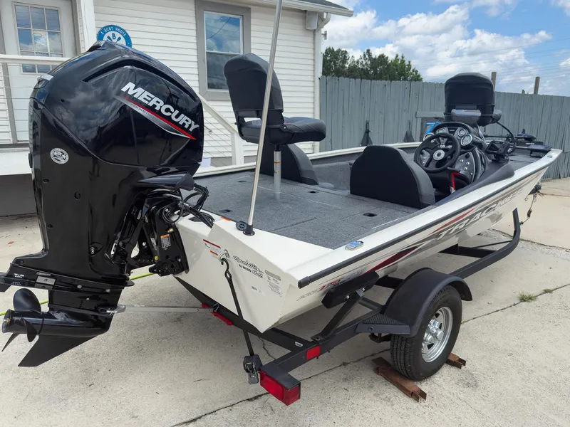 Slide: The Image of 2024 Tracker Pro Team 175 TXW boat with Mercury engine, parked on a trailer. - 5