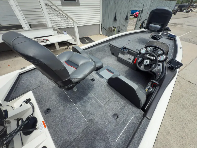 Slide: The Image of 2024 Tracker Pro Team 175 TXW boat interior with steering console and seating. - 7