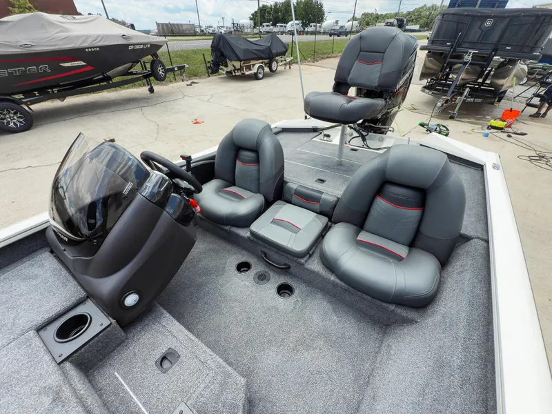 Slide: The Image of 2024 Tracker Pro Team 175 TXW boat interior with gray seating and steering console. - 9