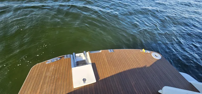 Slide: The Image of 2015 Beneteau 38 Gran Tourismo swim platform with teak decking on calm water. - 12