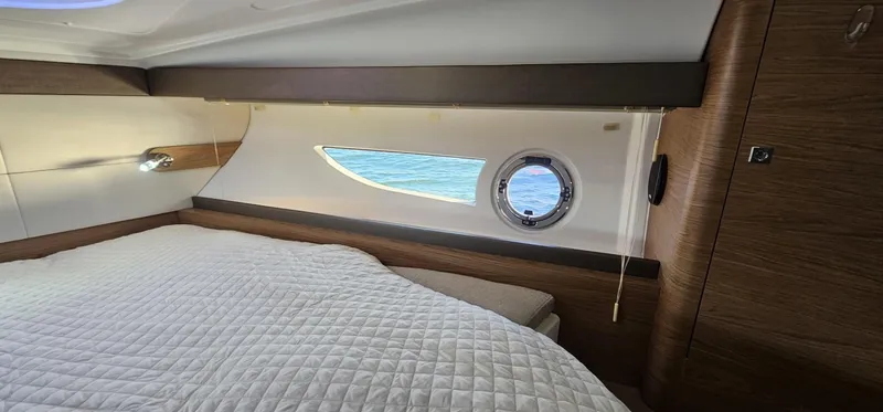 Slide: The Image of Interior cabin of 2015 Beneteau 38 Gran Tourismo with bed and porthole view. - 21