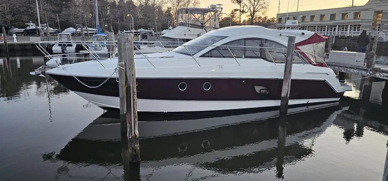 The Image of 2015 Beneteau 38 Gran Tourismo yacht docked in a marina at sunset. - 0