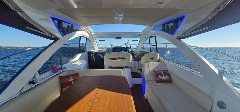 Slide: The Image of Interior view of 2015 Beneteau 38 Gran Tourismo yacht with modern seating and ocean backdrop. - 5