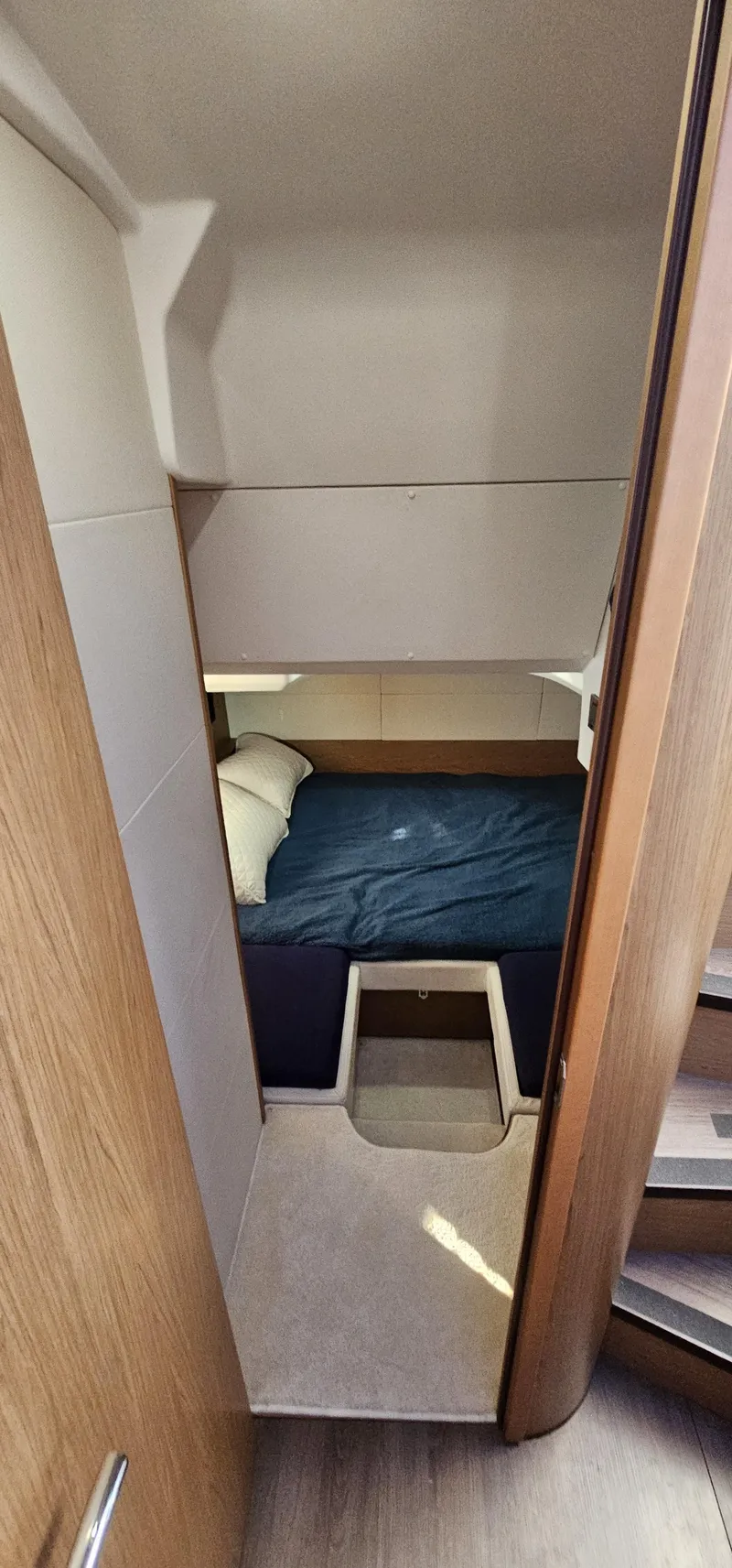 Slide: The Image of 2015 Beneteau 38 Gran Tourismo cabin interior with bed and wooden accents. - 25