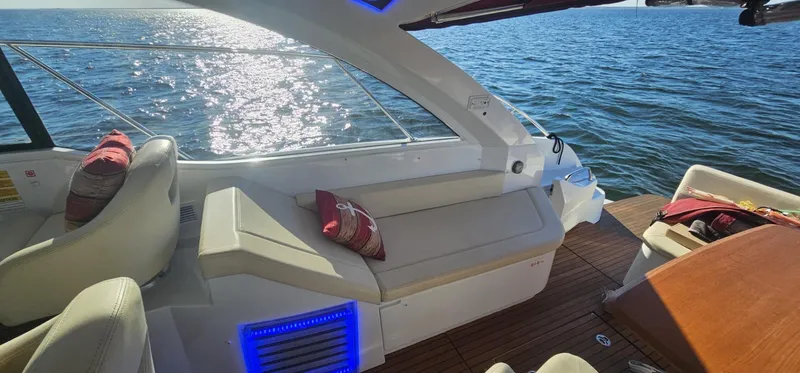 Slide: The Image of 2015 Beneteau 38 Gran Tourismo yacht interior with seating, cushions, and ocean view. - 10