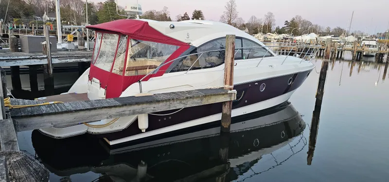 Slide: The Image of 2015 Beneteau 38 Gran Tourismo yacht docked at a marina with red canopy. - 1