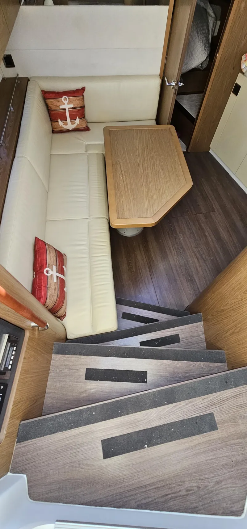 Slide: The Image of Interior of 2015 Beneteau 38 Gran Tourismo with cozy seating and wooden table. - 16