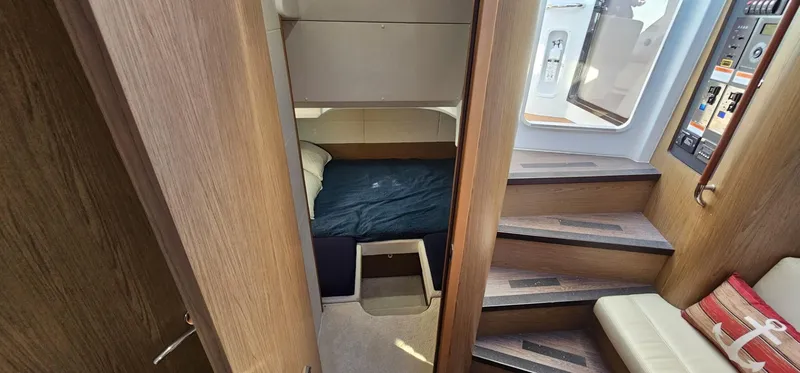 Slide: The Image of Interior cabin of 2015 Beneteau 38 Gran Tourismo yacht with wooden stairs and cozy bed. - 26