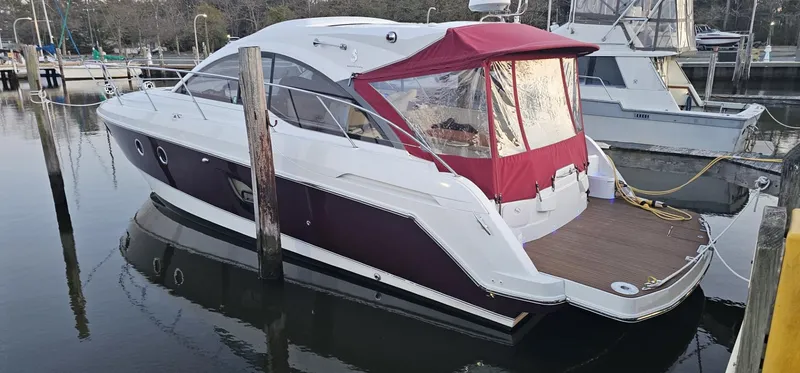 Slide: The Image of 2015 Beneteau 38 Gran Tourismo yacht docked with red canopy and sleek design. - 2
