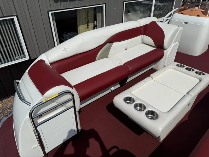 Slide: The Image of 2006 JC 266 TriToon Classic I/O boat with red and white seating and cup holders. - 10