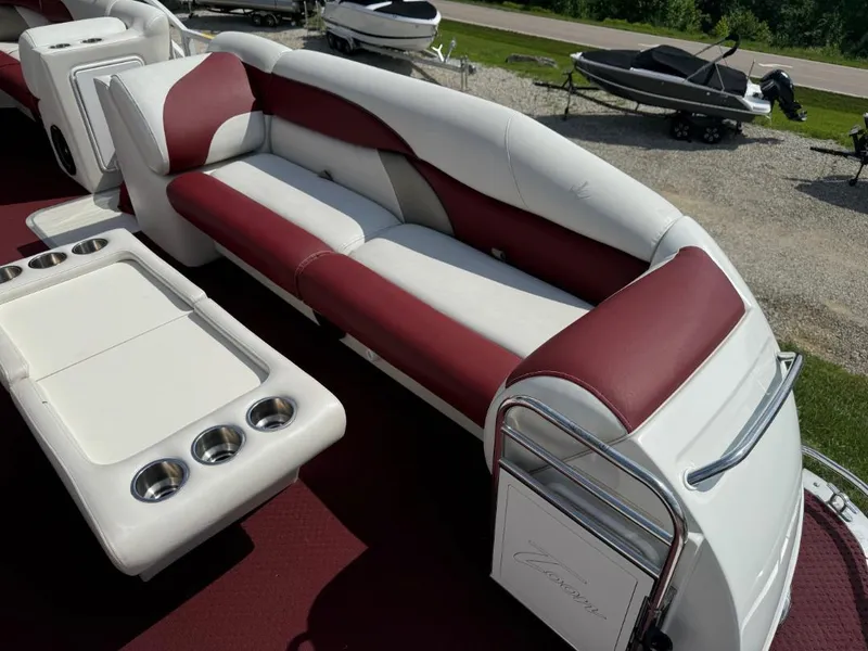 Slide: The Image of 2006 JC 266 TriToon Classic I/O boat interior with red and white seating and cup holders. - 11