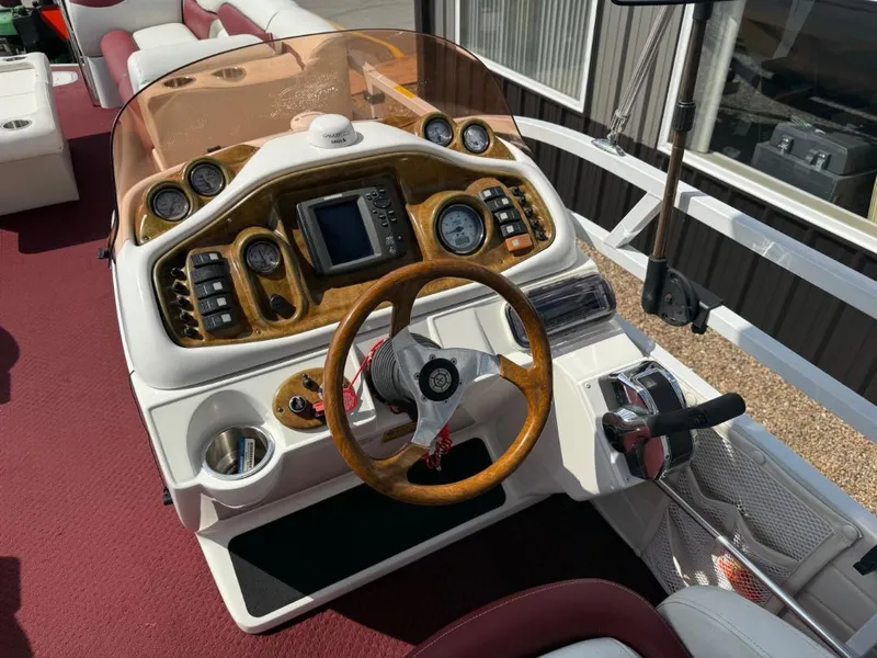Slide: The Image of Steering console of a 2006 JC 266 TriToon Classic I/O boat with wood accents. - 7