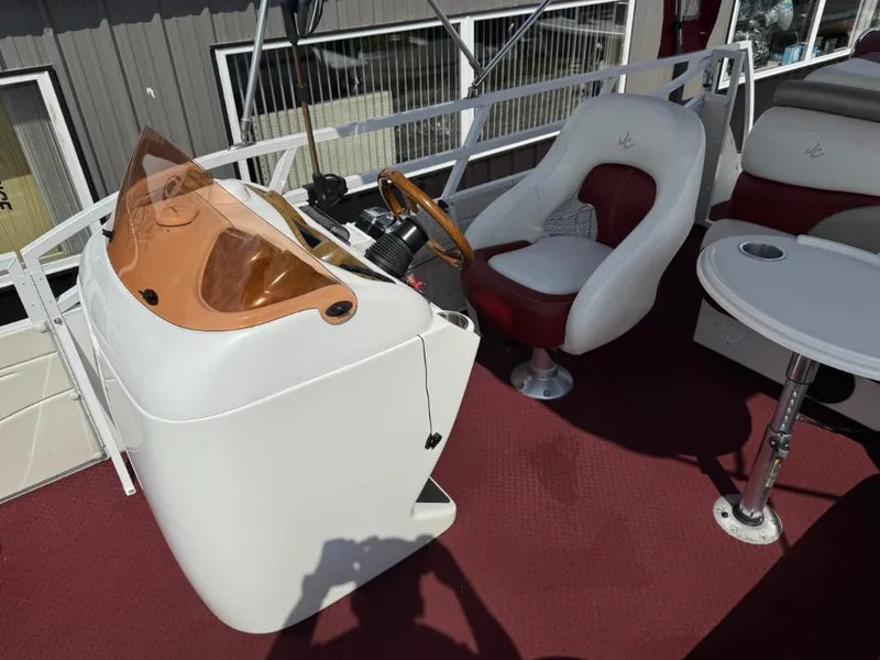 Slide: The Image of 2006 JC 266 TriToon Classic I/O boat interior with steering console and seating. - 8