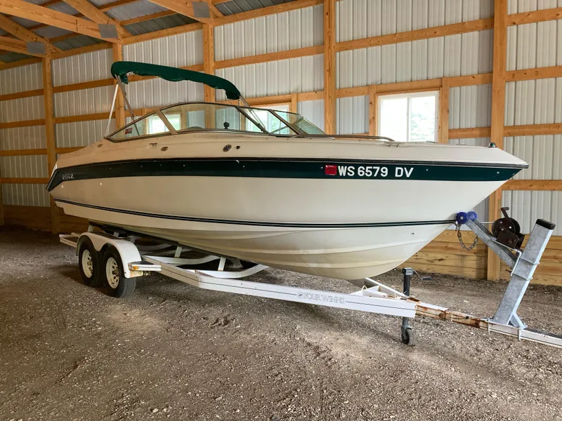 The Image of 1996 Regal 7.0 SE boat on trailer in a wooden garage. - 0