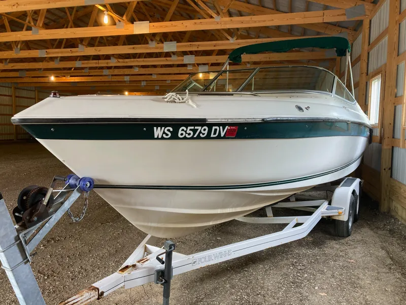 Slide: The Image of 1996 Regal 7.0 SE boat on trailer in wooden storage shed. - 1