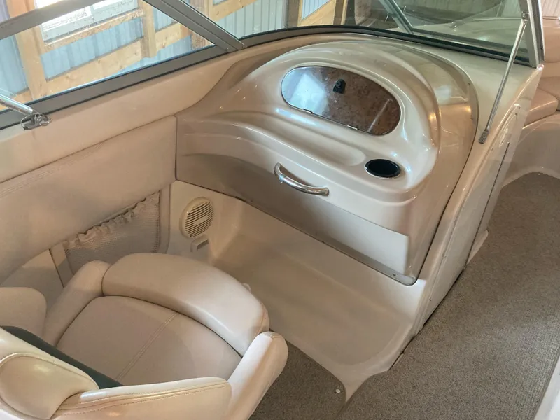 Slide: The Image of Interior of a 1996 Regal 7.0 SE boat, featuring beige seating and dashboard. - 10