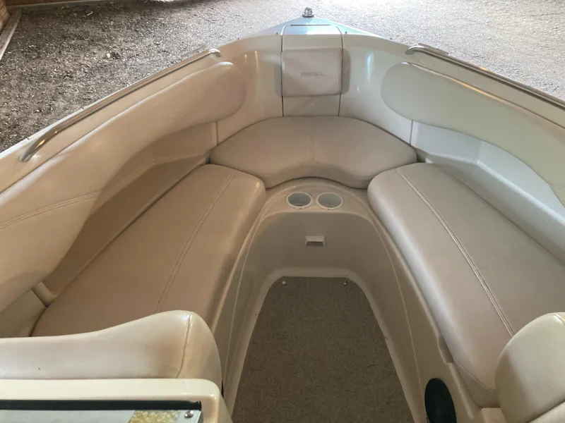 Slide: The Image of Interior of a 1996 Regal 7.0 SE boat with beige seating and cup holders. - 11