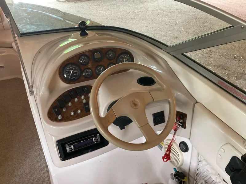 Slide: The Image of Interior view of a 1996 Regal 7.0 SE boat dashboard with steering wheel and controls. - 4