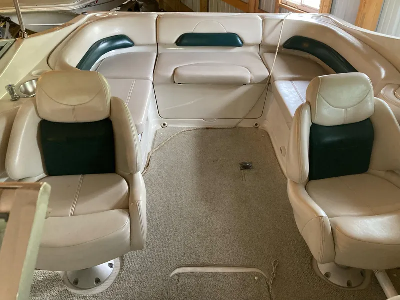 Slide: The Image of Interior of a 1996 Regal 7.0 SE boat with beige and green seating. - 6