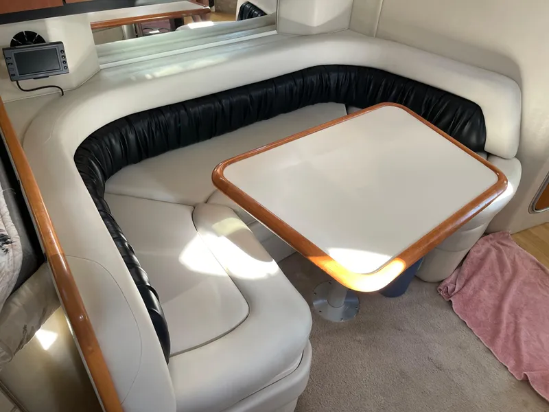 Slide: The Image of 1999 Wellcraft 3600 Martinique interior with cushioned seating and table. - 11