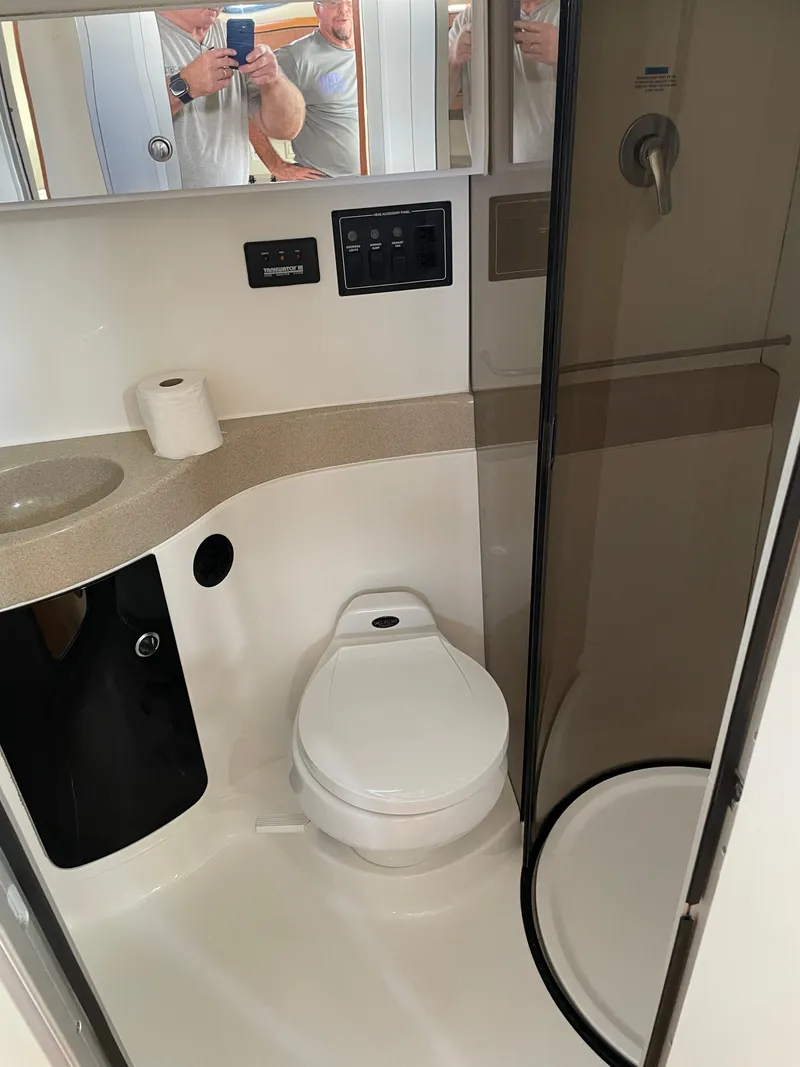 Slide: The Image of 1999 Wellcraft 3600 Martinique bathroom with toilet, sink, and shower. - 12