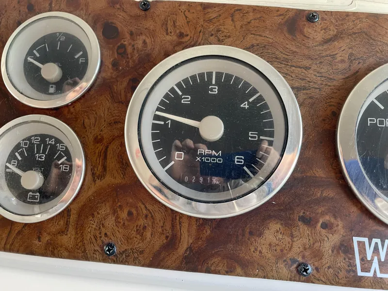 Slide: The Image of Dashboard gauges of a 1999 Wellcraft 3600 Martinique boat, featuring RPM and fuel indicators. - 14