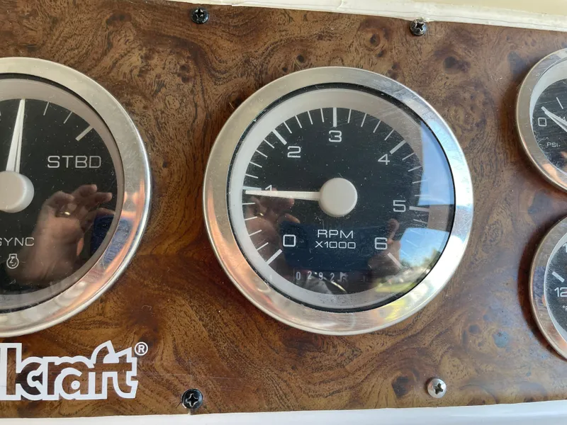 Slide: The Image of 1999 Wellcraft 3600 Martinique dashboard with RPM gauge and wood finish. - 15