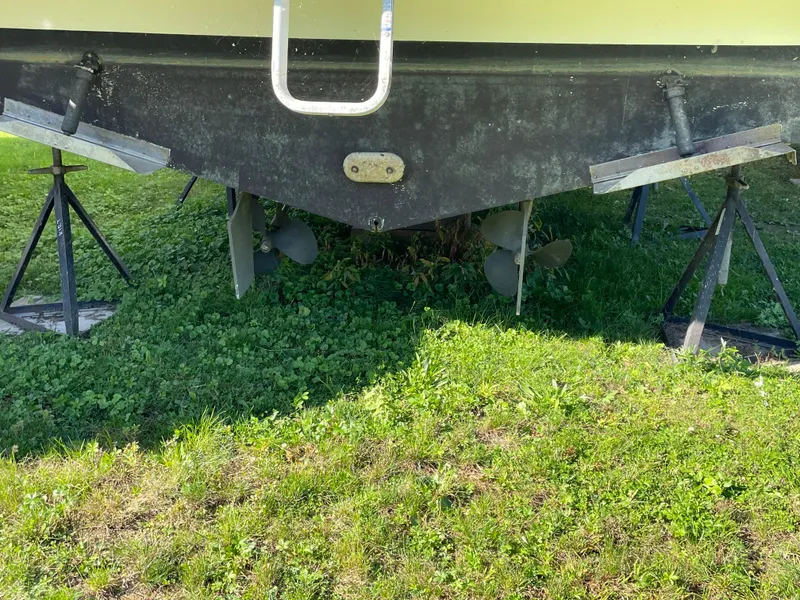 Slide: The Image of 1999 Wellcraft 3600 Martinique boat on stands, showing propellers and hull. - 5