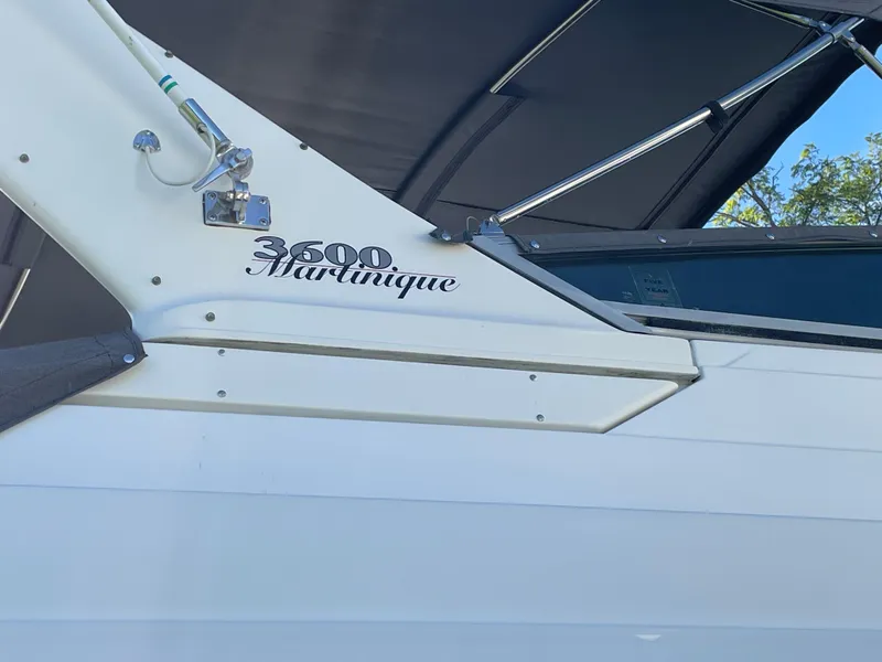 Slide: The Image of 1999 Wellcraft 3600 Martinique boat side view with logo and canopy. - 6
