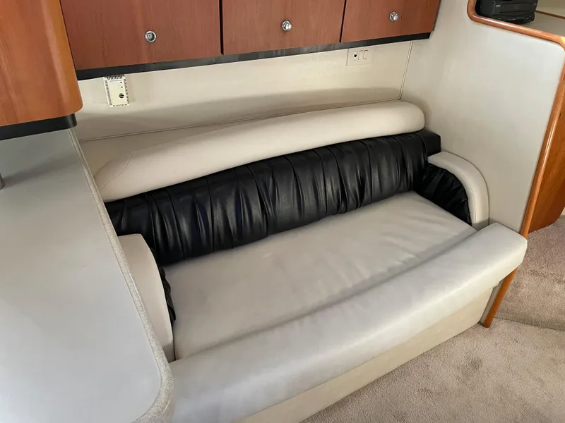 Slide: The Image of 1999 Wellcraft 3600 Martinique interior with leather seating and wooden cabinetry. - 9