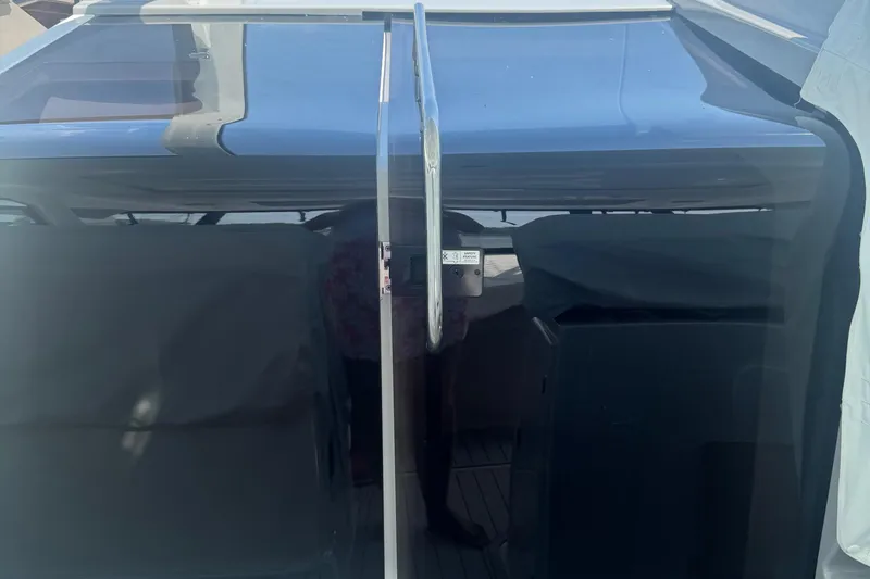 Slide: The Image of 2023 Beneteau Gran Turismo 32 yacht cockpit with sleek glass doors. - 15